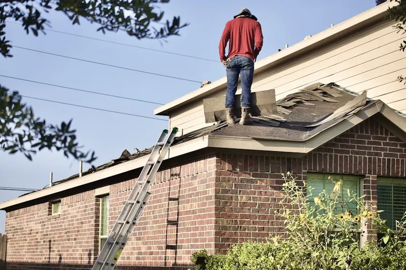 Professional roofer working on a residential roof in Autumn Woods